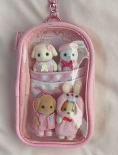 a pink purse with stuffed animals in it