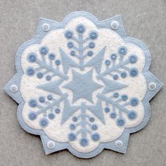 a white and blue snowflake on a gray surface