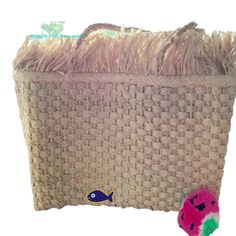 a large woven basket sitting on top of a table next to a stuffed animal toy