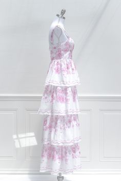 A uniquely feminine maxi, the La Vie En Rose dress features a lovely china pattern-inspired floral print in pink, structured boning the bodice, a tiered, full-length skirt, adjustable shoulder straps, a center-back zipper, and a gathered bustier-style neckline. Please Note, this item is final-sale only. . Details: S: Bust 32"-34", Waist 28" M: Bust 34"-36", Waist 30" L: Bust 36"-38", Waist 32" Length from Shoulder: 55" Skirt Length Waist to Hem: 43" No Stretch, Please Check Measurements Material Feminine Pink Maxi Dress With Rose Print, Fitted Floor-length Marie Antoinette Style Dress, Pink A-line Maxi Dress With Floral Print, Feminine Pink Rose Print Dress, Pink A-line Dress With Rose Print, Neckline Details, Rose Maxi Dress, Full Length Skirts, French Girl Style