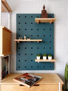 two wooden shelves with books on them in front of a wall decorated with polka dots