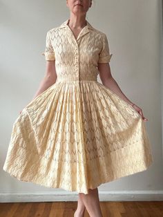 The loveliest buttercream cotton eyelet lace dress. With a flattering shape that's fitted through the bodice with a small notched collar and cuffed sleeves. The waist is nipped in and the skirt is full and pleated. With a 1950s Desmond label.  Fits a size extra small to small 34" bust  25.5" waist  Open hip 40" length In excellent vintage condition for its age, light wear but no major visible flaws 1950s Style Fitted Cream Vintage Dress, Fitted Cream Dress With Broderie Anglaise, Classic Cream Dress For Vintage Events, Cream 1950s Style Vintage Dress, Cream Fitted 1950s Style Dress, Fitted Cream Dress In 1950s Style, Cream Fitted Dress In 1950s Style, Vintage Cream Tea Length Dresses, Vintage Cream Tea-length Dresses