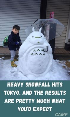 a kid standing next to a snow man with an umbrella