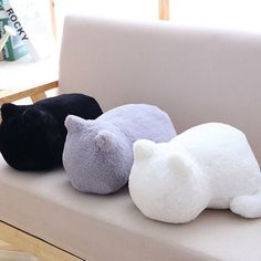 three stuffed animals are sitting on a couch