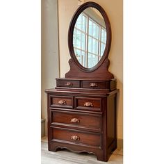 a wooden dresser with a mirror on top of it