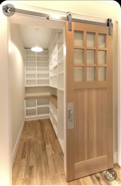 an empty walk in closet with wooden doors