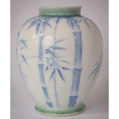 a blue and white vase with bamboo design