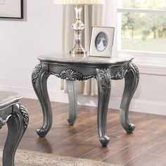 an ornately decorated table and bench in a living room