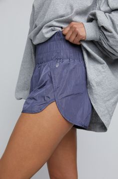 The uber-popular favorite Free People Way Home short. These vintage style warm-up running shorts feature a boldly smocked waistband with a low-rise silhouette and split hem. Description: Pull-on style Stretch waistband Relaxed fit Lined underneath Rise: 9.75 in Why We Love: Flattering fit for legsFabric: 100% NylonCare: Machine wash cool, hang dry (dries quickly) Athleisure Shorts With Elastic Waistband And Short Inseam, Athleisure Shorts With Elastic Waistband, Sporty Spring Shorts With Waistband, Sporty Short Bottoms With Pull-on Style, Nylon Athletic Shorts With Elastic Waistband, Sporty Stretch Shorts With Banded Waist, Casual Workout Athletic Shorts, Sporty Shorts With Banded Waist, Casual Athletic Shorts With Waistband