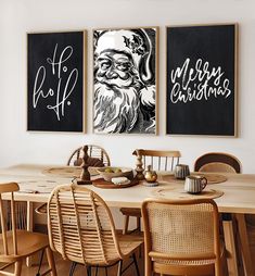 two christmas cards hang on the wall above a dining room table