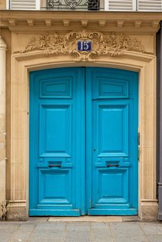 two blue doors are open in front of a building