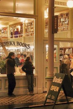 people standing in front of a book store at night