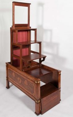 an antique wooden bed with drawers and mirror