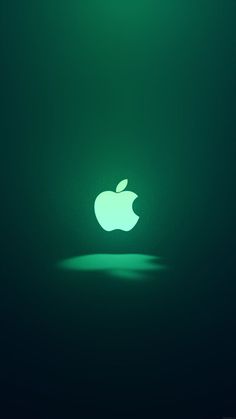 an apple logo is glowing in the dark green light, with only one shadow on the floor