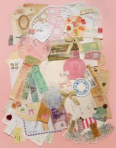 an art work with many different types of paper and doily on pink background,