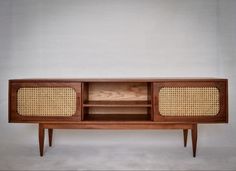 an old fashioned wooden cabinet with wicker inserts on the front and sides, against a white background