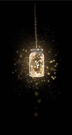 a glass jar filled with lots of lights on top of a metal ball chain hanging from a