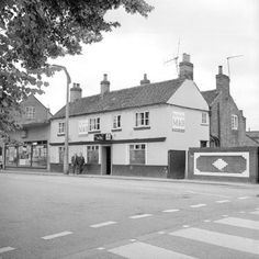 an old black and white photo of a street corner