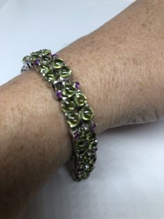 This Peridot and Ruby bracelet is very lively and bright. The stones are deep colors and well matched. The sterling silver is plated with rhodium to protect the bracelet from tarnish and give the appearance of white gold. My jeweler can shorten this for a $20 fee 7.5 inches All jewelry is shipped in a nice gift box. Check out our over a THOUSAND great reviews Engraving is $4 per letter and is not always perfect depending on the piece. It can take a few days if the jeweler is busy. This is payabl Green Sterling Silver Bangle Bracelet, Green Peridot Round Bracelets, Green Sterling Silver Jubilee Bracelet, Green Multi-stone Bracelets For Gifts, Formal Green Sterling Silver Bracelet, Anniversary Green Sterling Silver Bracelets, Green Multi-stone Round Bracelets, Green Peridot Bracelet Jewelry, Green Peridot Bracelet