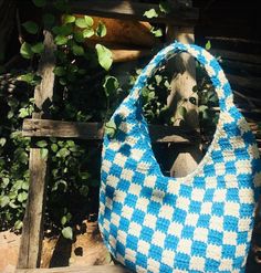 a blue and white bag sitting on top of a wooden bench