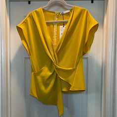 Cheerful Sophisticated Short Sleeved Blouse With Modern Accented Front Twist, With Classic Zipper On Back Of Blouse. Chic Sleeveless Blouse For Office, Chic Sleeveless Office Blouse, Sleeveless Blouse For Office In Spring, Spring Workwear Sleeveless Blouse, Yellow V-neck Top For Party, Elegant Sleeveless Blouse For Day Out, Sleeveless Blouse For Night Out In Spring, Elegant Yellow Summer Blouse, Elegant Yellow V-neck Top