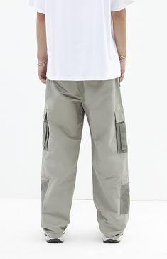 The Shadow Baggy Cargo Pants from PacSun offer a relaxed fit with wide legs, crafted from a durable cotton-nylon blend. Featuring a drawstring waistline, reinforced seams, side entry pockets, and cargo pockets with zipper details, these pants seamlessly blend practicality with contemporary style.


	Drawstring waistline
	Side pockets
	Welt back pockets
	Relaxed fit
	Cargo pockets with zip detail
	30" Inseam
	19.5" Leg opening
	Rigid
	66% Cotton, 34% nylon
	Machine washable
	Measurements taken from a size medium
	Model is wearing size medium
	Model Measurements: 6'2” Height, 30” Waist, 32” Inseam Solid Parachute Pants With Cargo Pockets For Streetwear, Urban Solid Color Straight Leg Parachute Pants, Urban Parachute Pants With Tapered Leg And Multiple Pockets, Urban Parachute Pants With Multiple Pockets And Tapered Leg, Utility Cotton Parachute Pants Full Length, Cotton Cargo Pants With Elastic Waistband For Outdoor, Cotton Cargo Pants With Elastic Waistband For Outdoor Activities, Khaki Wide Leg Cargo Pants For Outdoor Activities, Khaki Wide Leg Cargo Pants For Outdoor