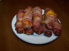 bacon wrapped in cheese on a white plate