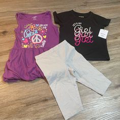 Purple Tank Top Dress Like Shirt Is Brand Extremely Me!, Size 5/6, Is Cinched At Sleeves With Fabric Band And At Bottom Hem With Elastic. Top Is In Euc. Black Shirt Is Jumping Beans Active, Size 5t, And Nwt. Silver Sparkle Shorts Are Bermuda (Knee) Length, Cartwheel Style, And Are 365 Kids Brand And A Size 5. Stretch Playful Tops For Playtime, Playful Stretch Tops For Playtime, Playful Stretch Black Tops, Playful Black Stretch Top, Black Playful Stretch Top, Cute Short Sleeve Purple Set, Playful Fitted Purple Tops, Casual Stretch Sets For Playwear, Casual Fitted Tops For Playtime