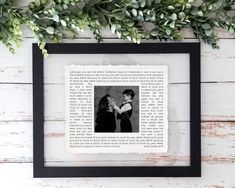 an old book page with a photo of two people holding each other in front of some greenery