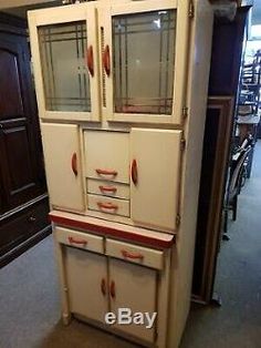 an old fashioned kitchen cabinet is on display