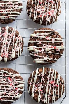 chocolate cookies with white icing and candy canes on a cooling rack, ready to be eaten