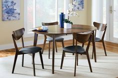 a dining room table with four chairs around it