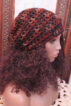 a mannequin head wearing a brown and red crochet knitted hat