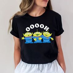 a woman wearing a black shirt that says hooo with two cartoon characters on it