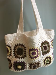 a white crocheted bag hanging from a hook