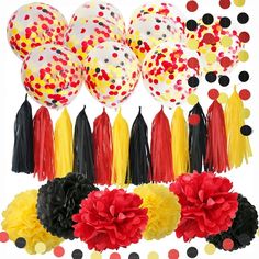 a bunch of balloons with tassels and pom poms