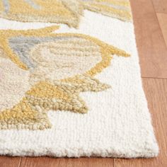 a close up of a rug on a wooden floor with wood floors and white carpet