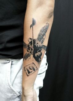 a man with a tattoo on his arm is holding a golf club and an eagle