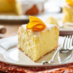 a piece of cake with icing and orange peels on it sitting on a plate