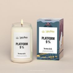 a candle that is next to a box on a table with the words platform 9 % in front of it