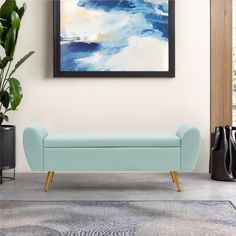 a blue bench sitting in front of a painting on the wall