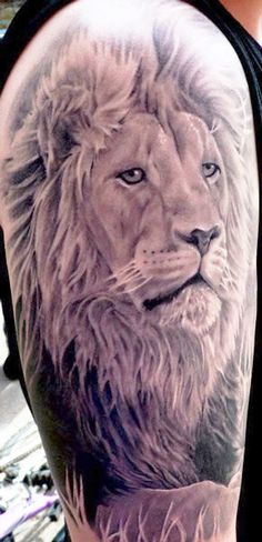 a man with a lion tattoo on his arm