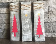 three christmas trees painted on wood with twine