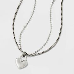 Accessorize your casual attire with this Heart Charm with Chain Necklace from Universal Thread™. The silver-tone necklace is composed of two chains and comes adorned with a heart charm dangling down at the center for a lovely look. With a lobster-clasp closure and an extender chain that lets you customize the length to your liking, this two-chain necklace is easy to pair with an array of necklines for versatile styling options you're sure to appreciate. Universal Thread™: The denim collection th Trendy Silver Heart Necklace With Lobster Clasp, Denim Collection, Casual Attire, Universal Thread, A Heart, Heart Charm, Lobster Clasp, Silver Tone, Chain Necklace