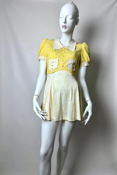 Vintage 60s MOD Yellow Babydoll Mini Dress With Pointed Collar. Adorable Vintage 60's MOD Playful Yellow Babydoll Mini Dress.  This Fantastic Original 60s Dress Features Both The Bodice And Puffed Sleeves In A Yellow Ribbed Polyester With A Contrasting Floral Nylon Print Fabric.  The Skirt, Edging To The Puffed Sleeves, Classic 60s Pointed Collar, And The Front Pockets Are All Done In The Floral Nylon. To Add To The Character Of This Dress, Decorative Yellow Plastic Buttons Are Positioned Down The Front As Well As On The Pockets. Has Back Metal Back Zipper. This Sweet Piece Is Truly a Flashback To The Past. Oh So Cute And Very Short. No size tag. Runs like a Size Extra Small/Small. Preowned Vintage Condition. Shows some vintage wear. Some Thread Issues Perhaps On Seams. Some Wear To The Ny Vintage Fitted Mini Dress For Daywear, Vintage Fitted Mini Dress With Short Sleeves, Fitted Yellow Vintage Dress With Short Sleeves, Yellow Fitted Vintage Dress With Short Sleeves, Fitted Retro Dress With Doll Collar, Yellow Fitted Short Sleeve Vintage Dress, Vintage Mini Dress With Doll Collar For Spring, Retro Fitted Dress With Doll Collar, Retro Yellow Mini Dress