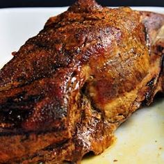 a piece of meat sitting on top of a white plate