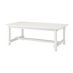 the table is white and has two drawers on one side, with an open shelf underneath it