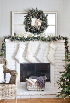 a fireplace decorated for christmas with stockings and stocking