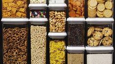 an assortment of cookies, crackers, cereals and pretzels in plastic containers