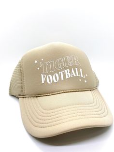 This custom designed tan trucker hat is super cute and fun! Featuring the words “Tiger Football” in white, this hat will make the perfect ball game accessory for your next sporting event. Football Hat Designs, Ladies Football Hat, Tiger Football, Sporting Event, Circuit Projects, Custom Football, Football Mom, Sport Event, Hat Designs